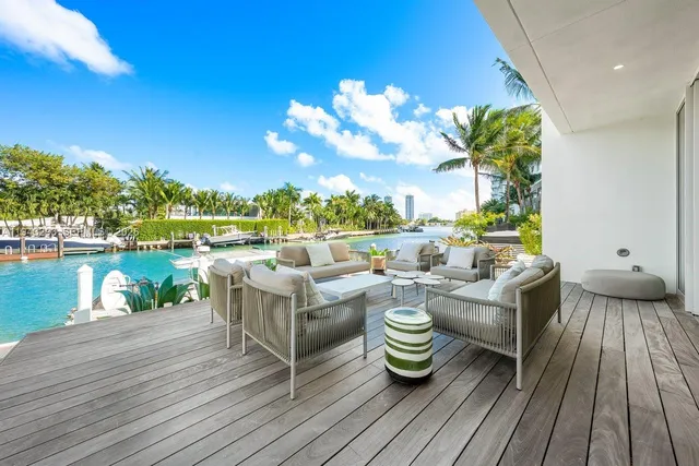 a view of a patio with table and chairs and potted plants