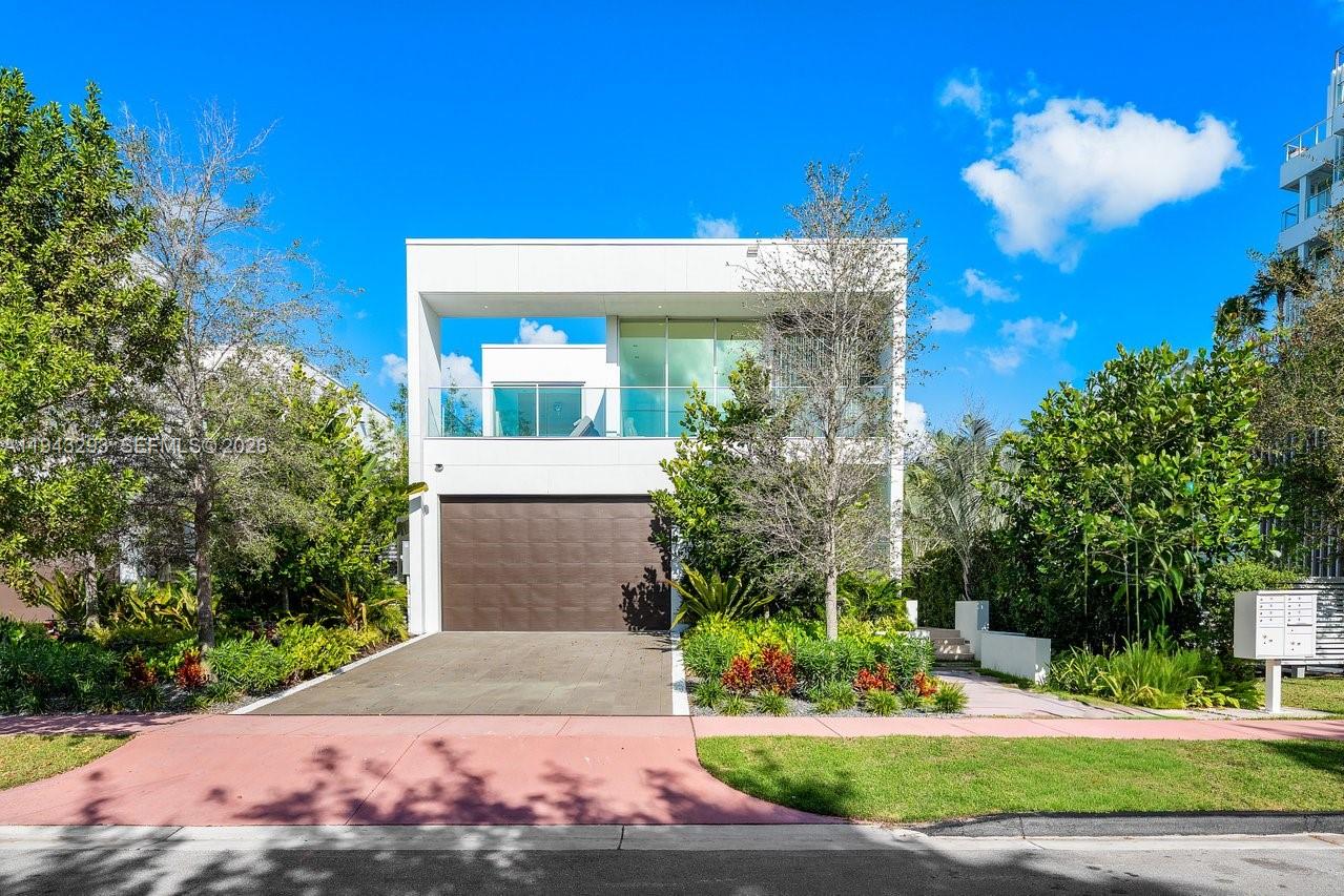 1011 West 48th Street Miami Beach, FL 33140 - Photo 3 of 44 a front view of a house with garden