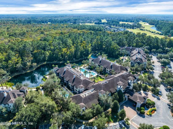 an aerial view of a house with a yard