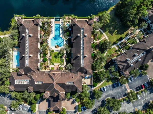 a view of a house with swimming pool and chairs