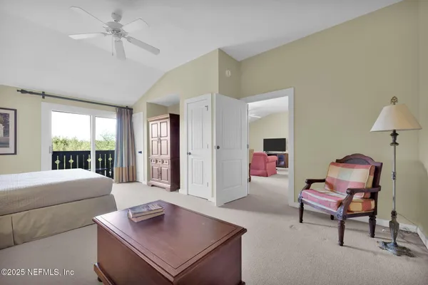 a view of a balcony with furniture and floor to ceiling window