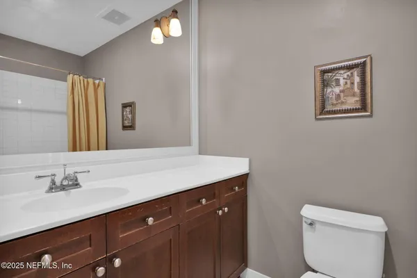 a en suite bathroom with a sink and a mirror