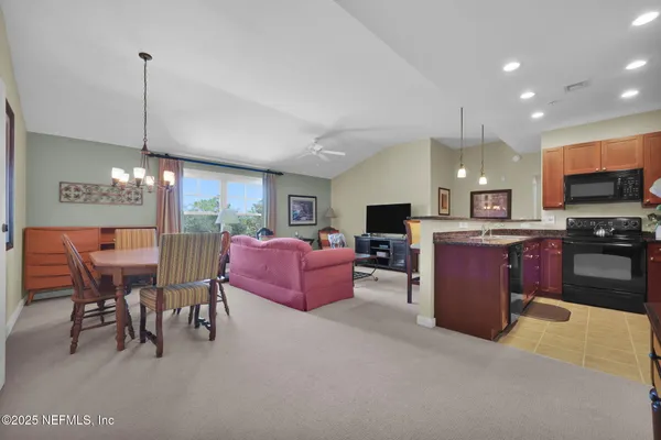a kitchen with microwave a stove and a sink
