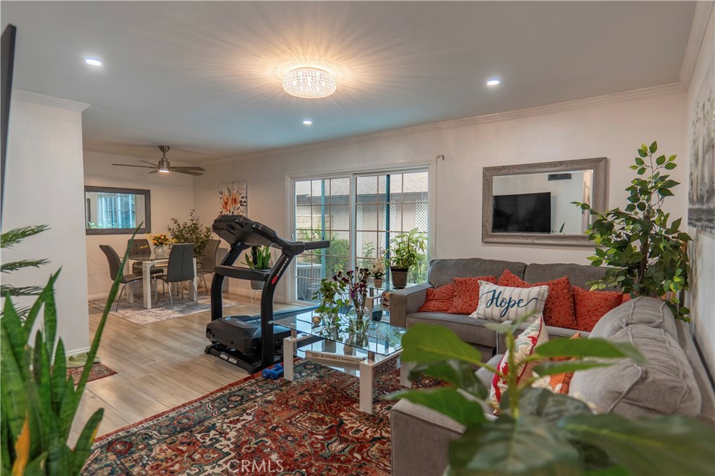 7554 Corbin Avenue, Unit 4 Reseda, CA 91335 - Photo 1 of 22 a living room with furniture gym equipment and a chandelier