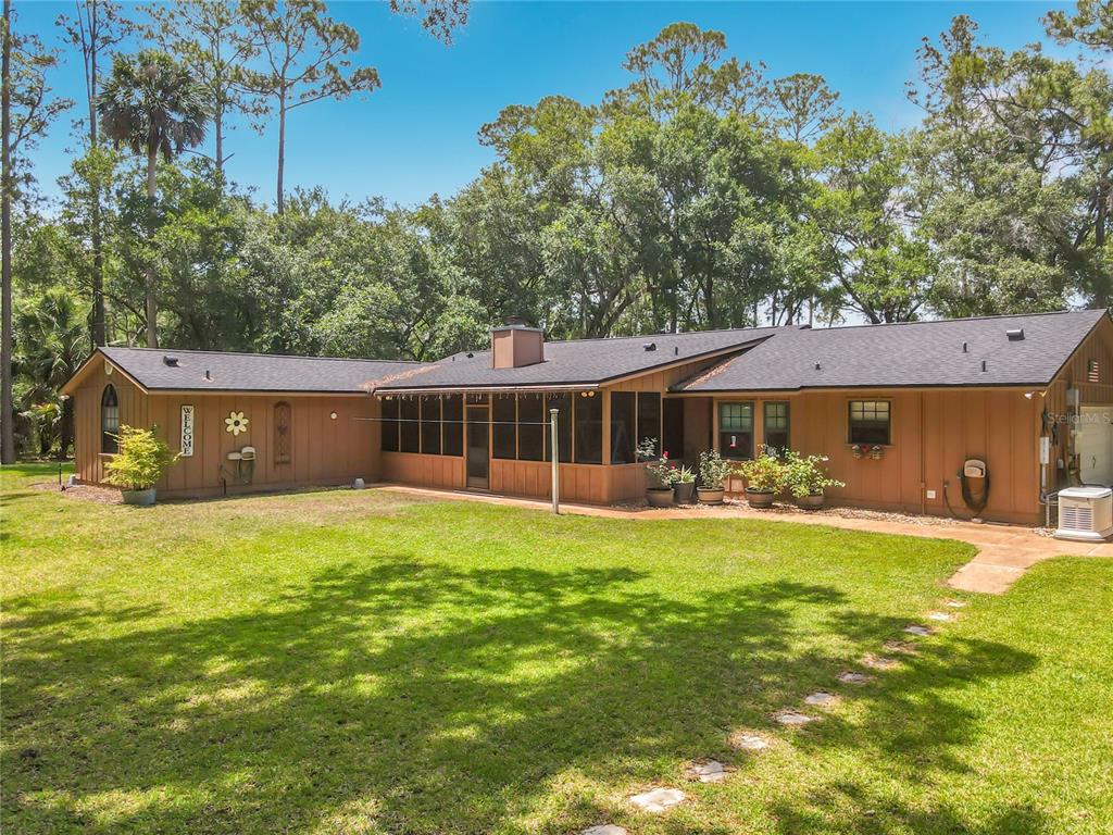 1395 Maytown Road Osteen, FL 32764 - Photo 45 of 65 a front view of a house with swimming pool having outdoor seating