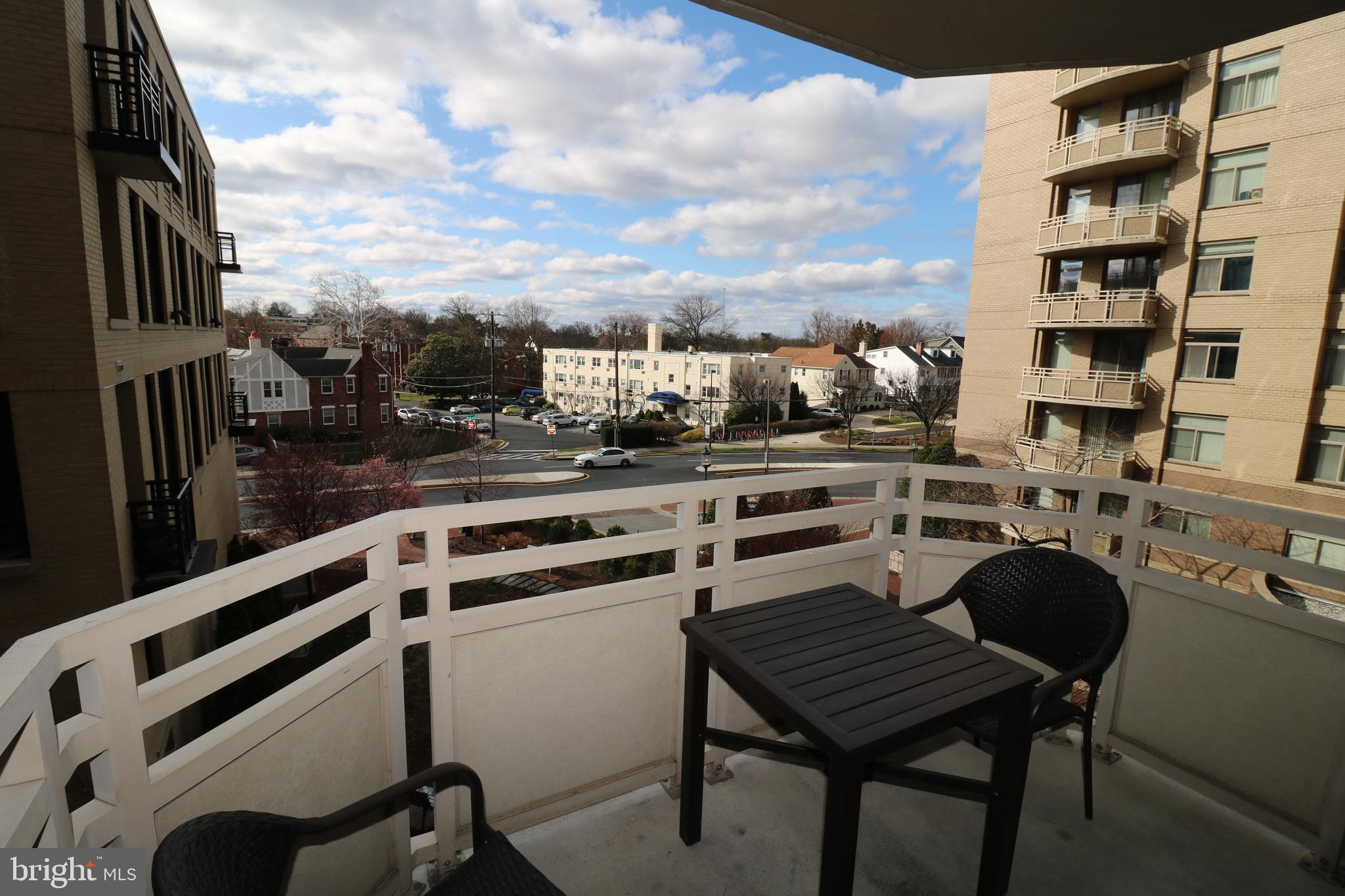 7111 Woodmont Avenue, Unit 415 Bethesda, MD 20815 - Photo 2 of 10 a view of a chairs and table in the terrace