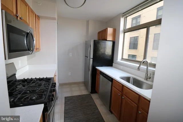 a kitchen with a sink and a refrigerator