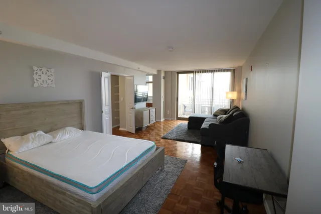 a living room with hard wood floors and a couch