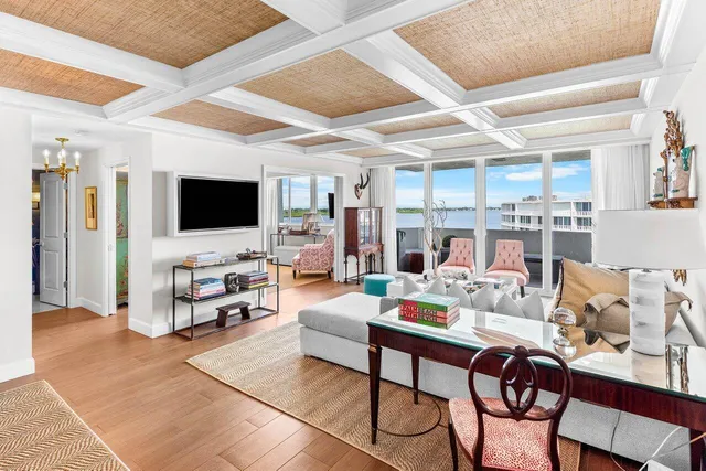 a living room with furniture and kitchen view