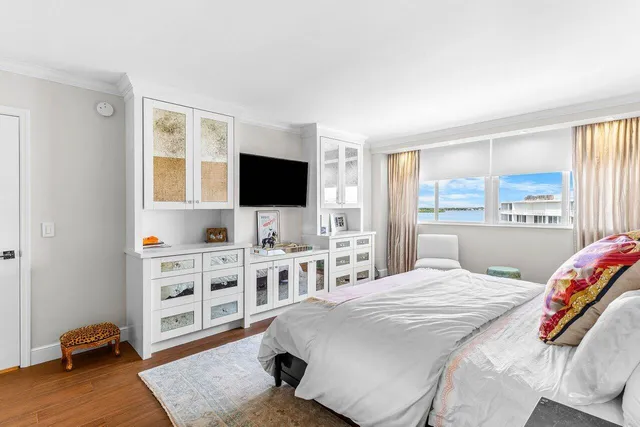 a living room with furniture a wooden floor and a large window