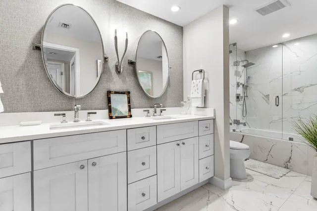 a bathroom with a sink toilet and shower