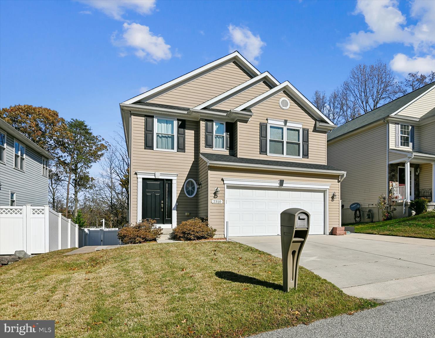 2310 228th Street Pasadena, MD 21122 - Photo 1 of 45 a front view of a house with a yard and garage