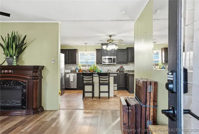 a kitchen with stainless steel appliances a refrigerator a stove top oven a sink and dining table