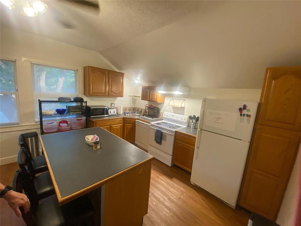 4507 Avenue F, Unit B Austin, TX 78751 - Photo 4 of 5 a kitchen with a refrigerator a stove top oven a sink and cabinets