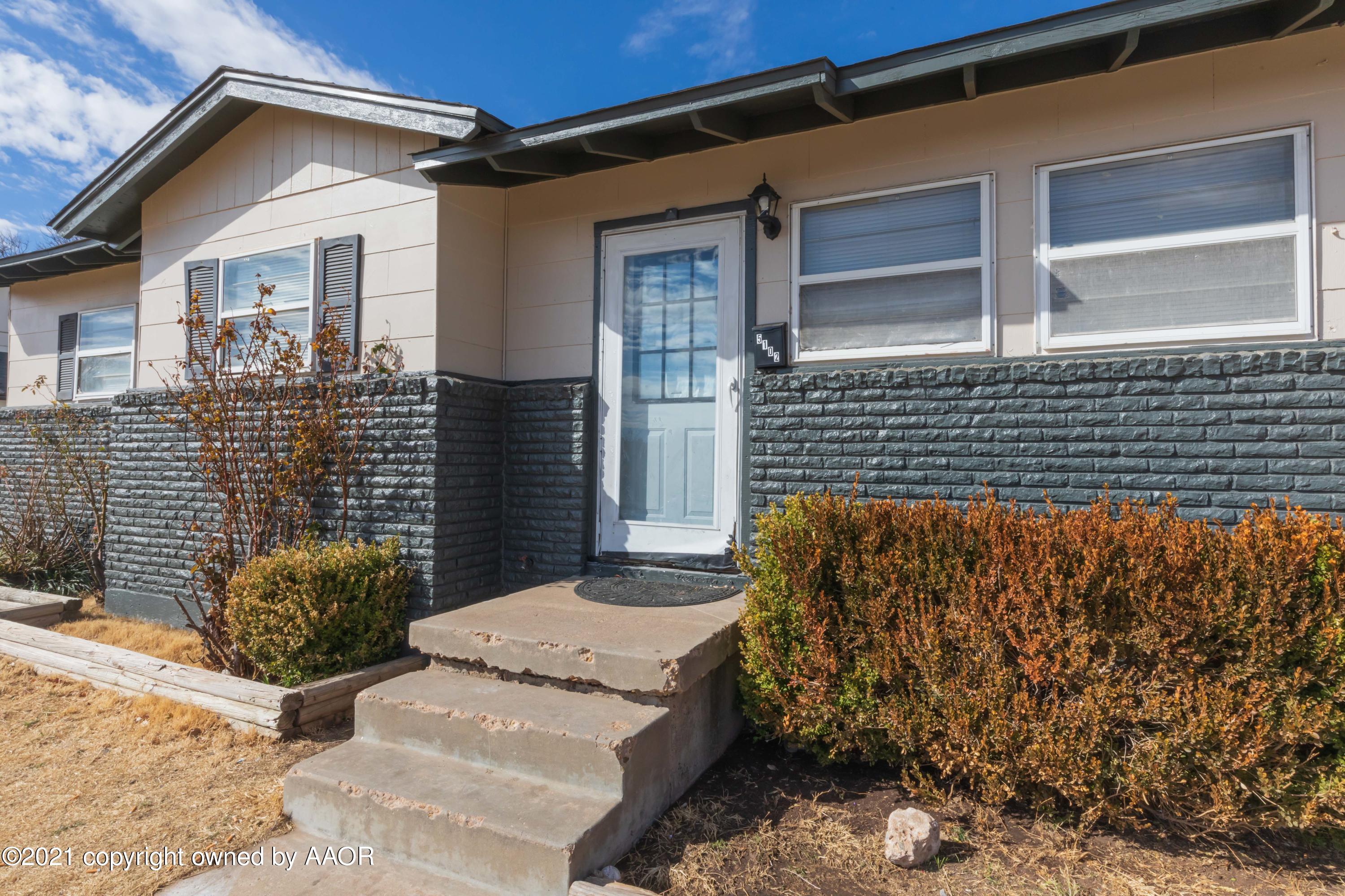 5102 South Travis Street Amarillo, TX 79110 - Photo 1 of 24 a view of a house with a door