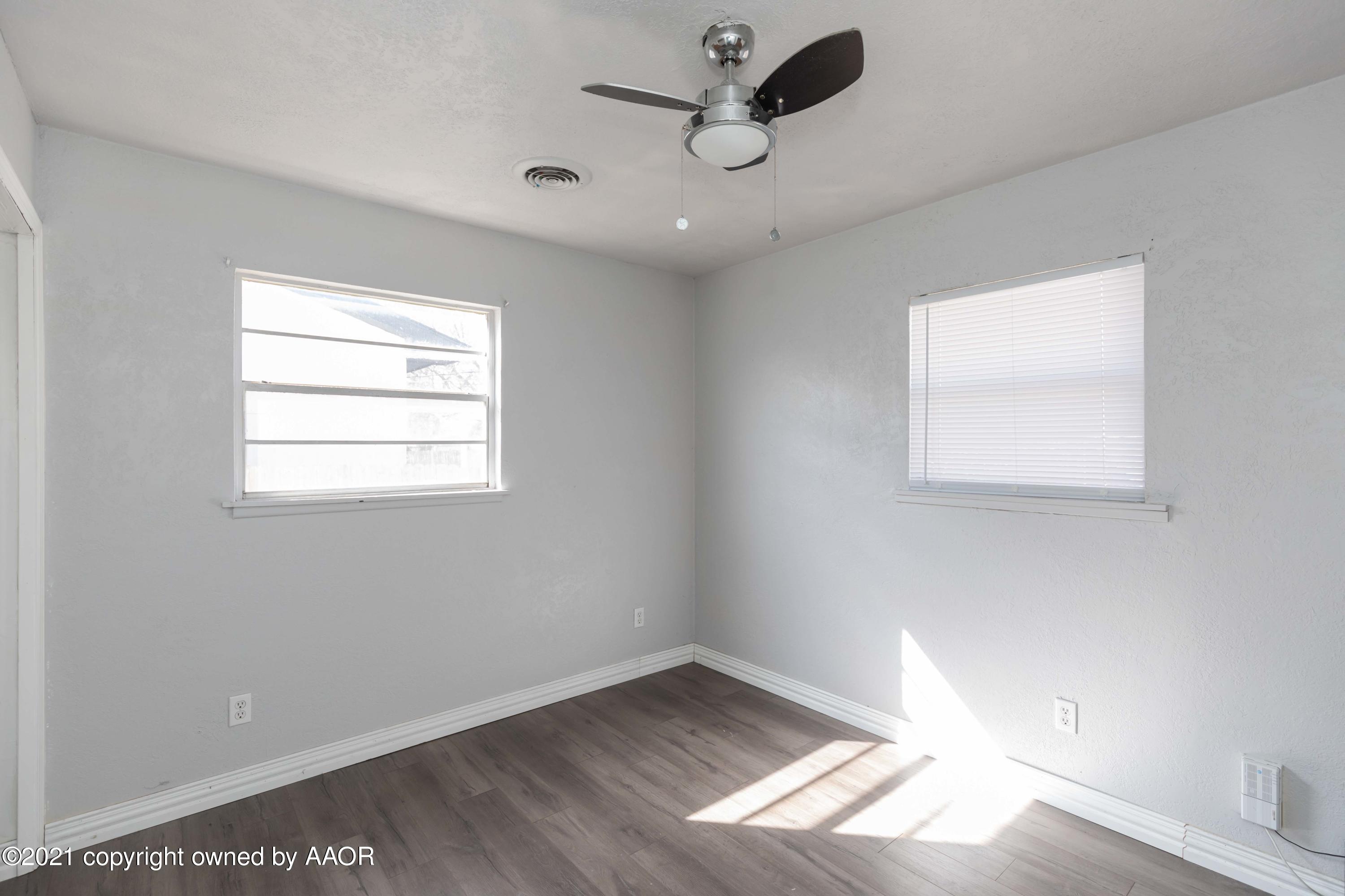 5102 South Travis Street Amarillo, TX 79110 - Photo 12 of 24 an empty room with a window
