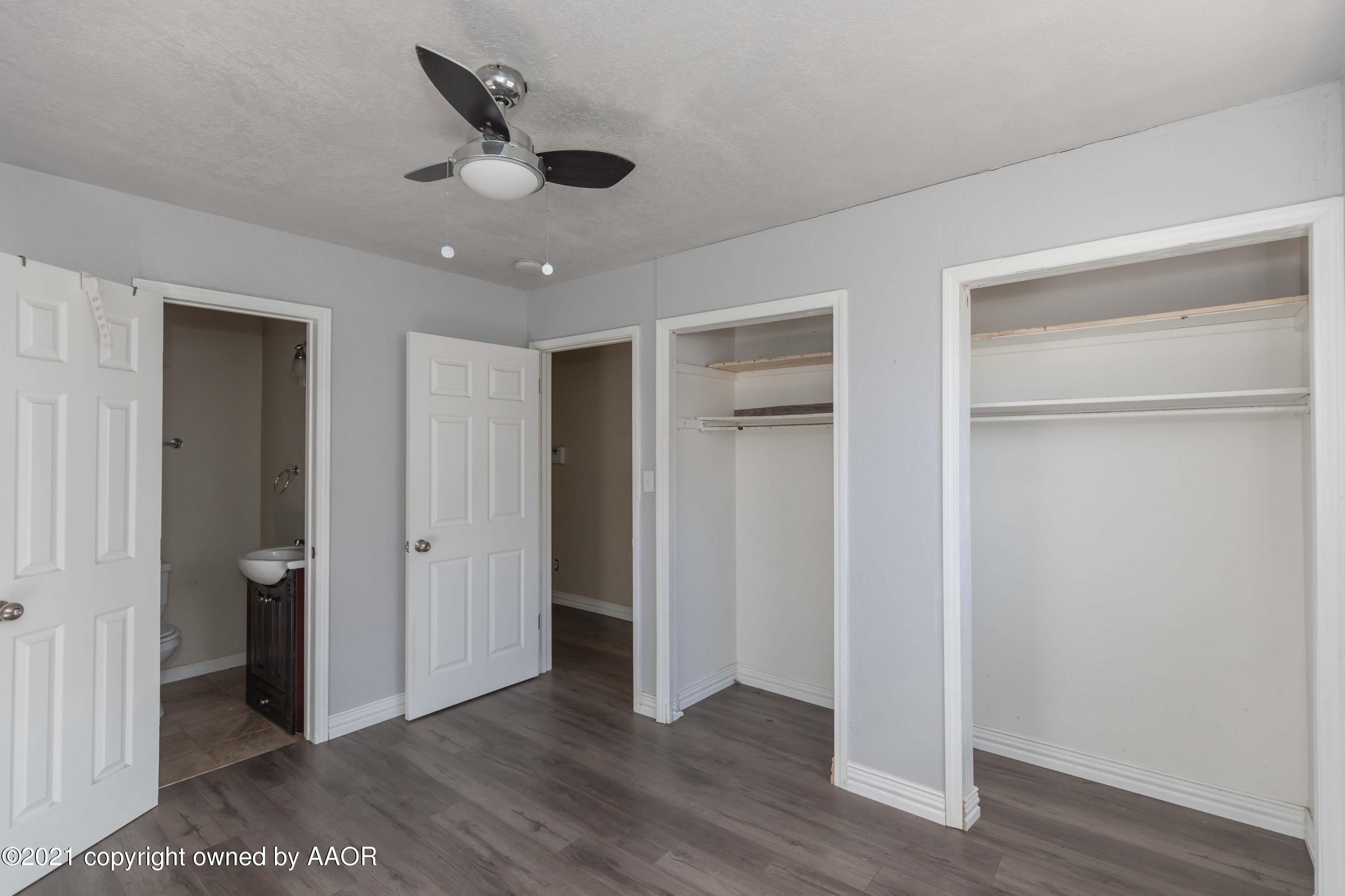 5102 South Travis Street Amarillo, TX 79110 - Photo 13 of 24 a view of an empty room and wooden floor