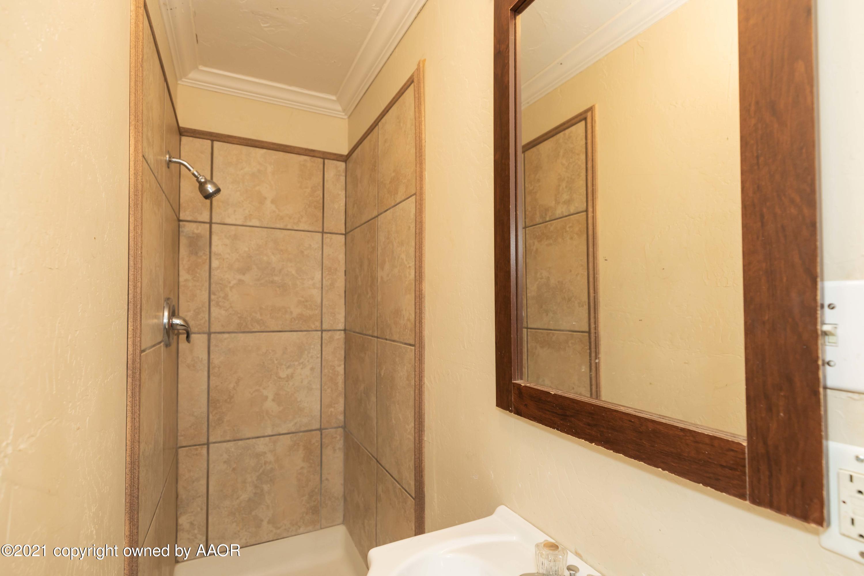 5102 South Travis Street Amarillo, TX 79110 - Photo 16 of 24 a bathroom with a shower and a sink