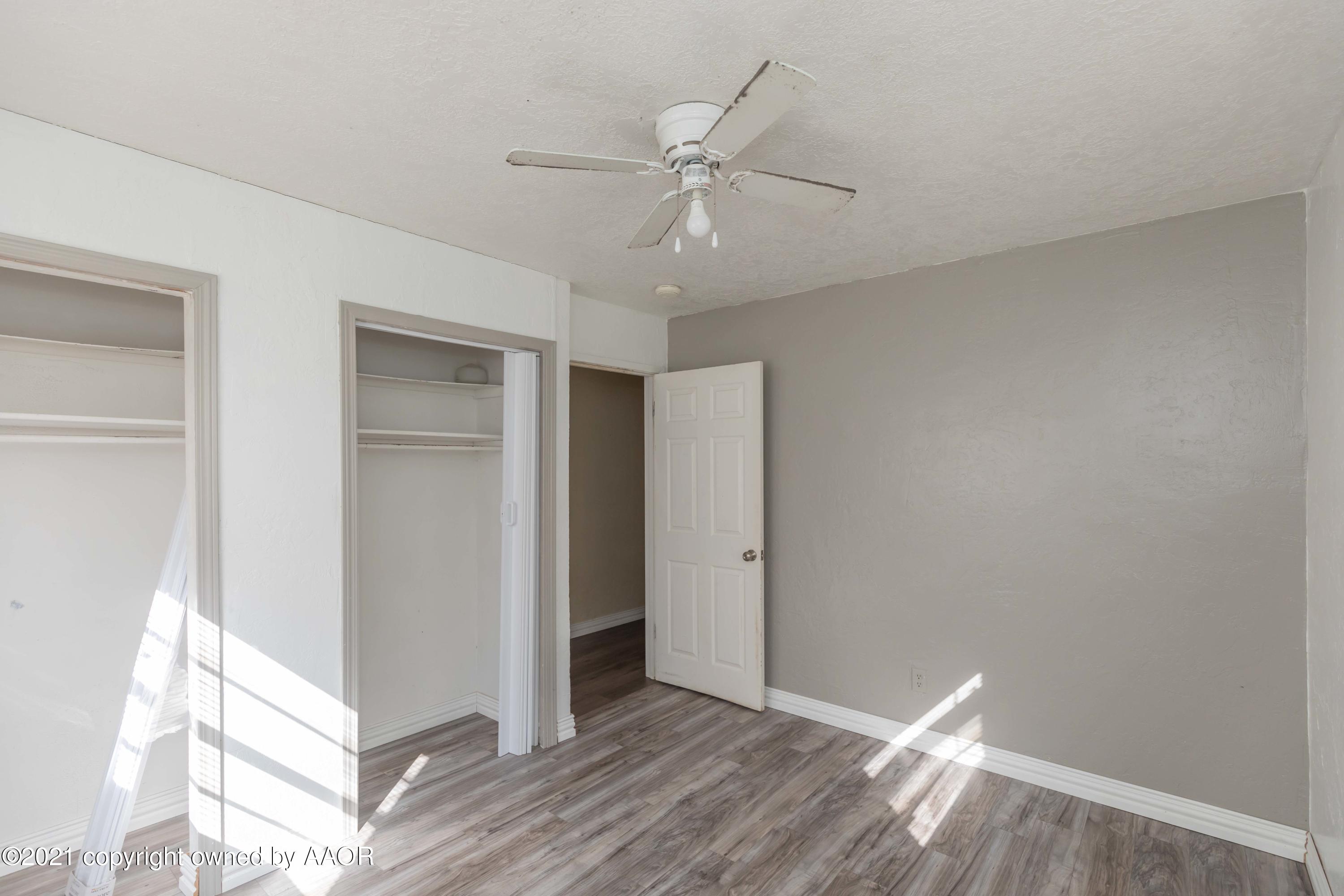 5102 South Travis Street Amarillo, TX 79110 - Photo 20 of 24 a view of an empty room with wooden floor and a window