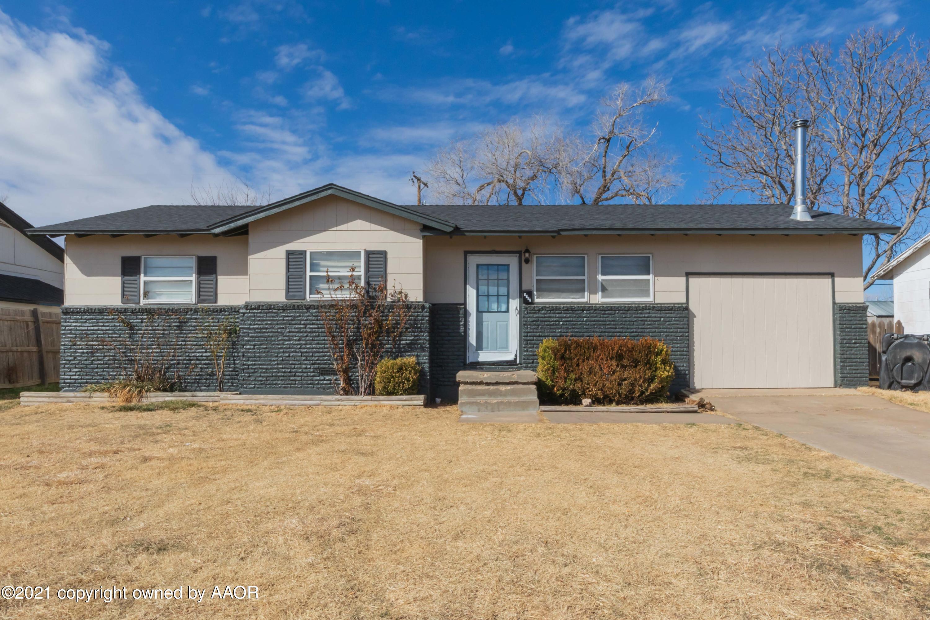 5102 South Travis Street Amarillo, TX 79110 - Photo 2 of 24 a front view of a house with a yard