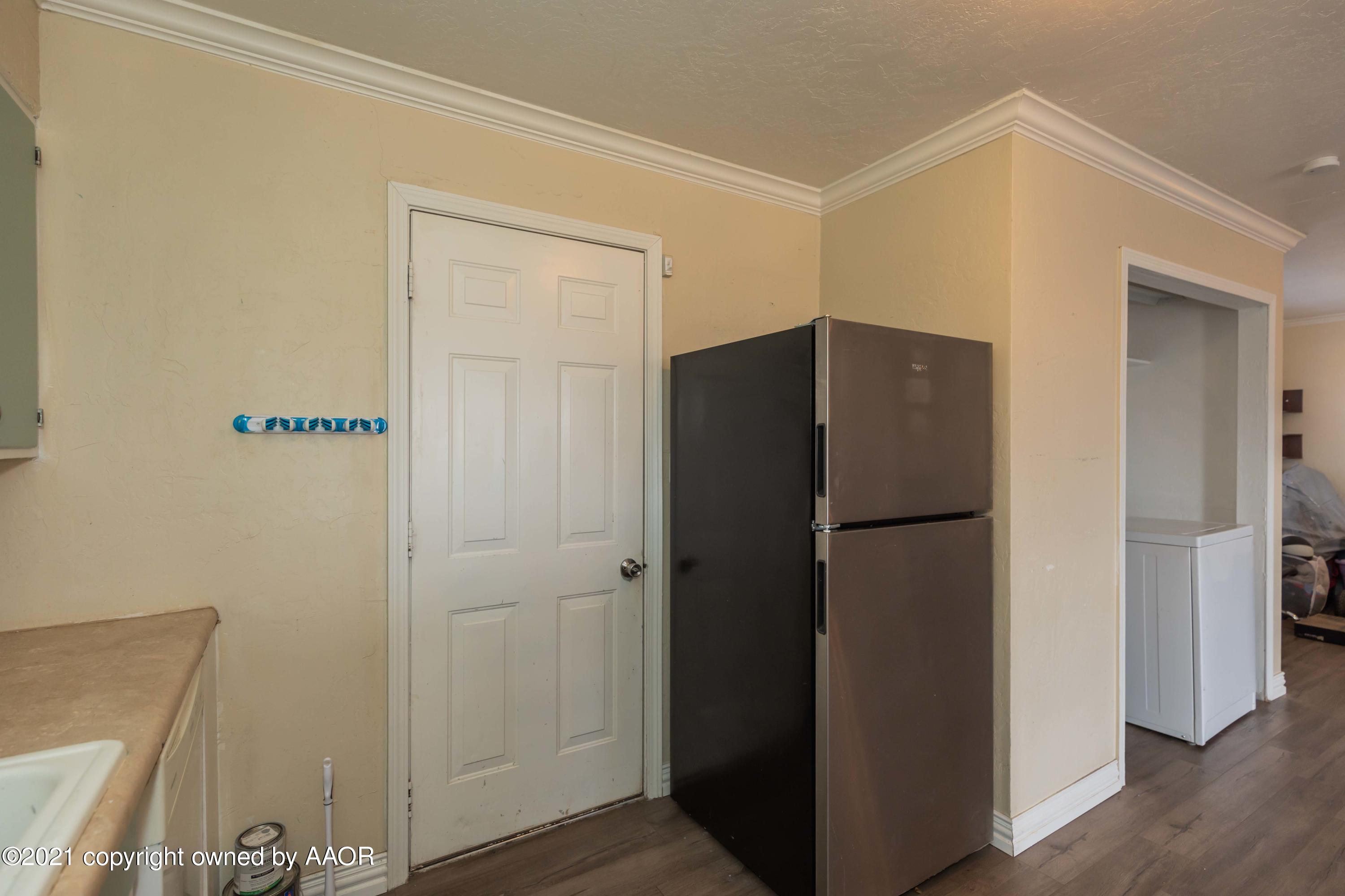 5102 South Travis Street Amarillo, TX 79110 - Photo 9 of 24 a refrigerator freezer sitting inside of a kitchen