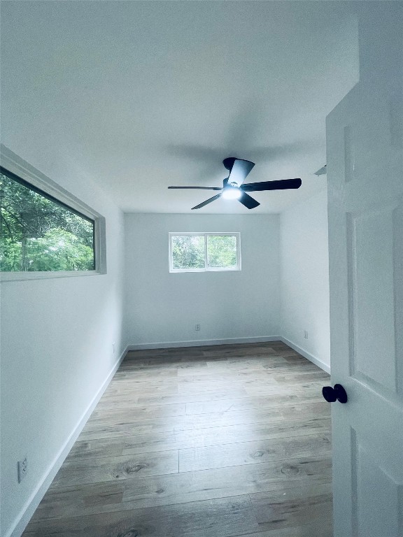7107 Guadalupe Street, Unit C Austin, TX 78752 - Photo 6 of 7 wooden floor in an empty room with a window