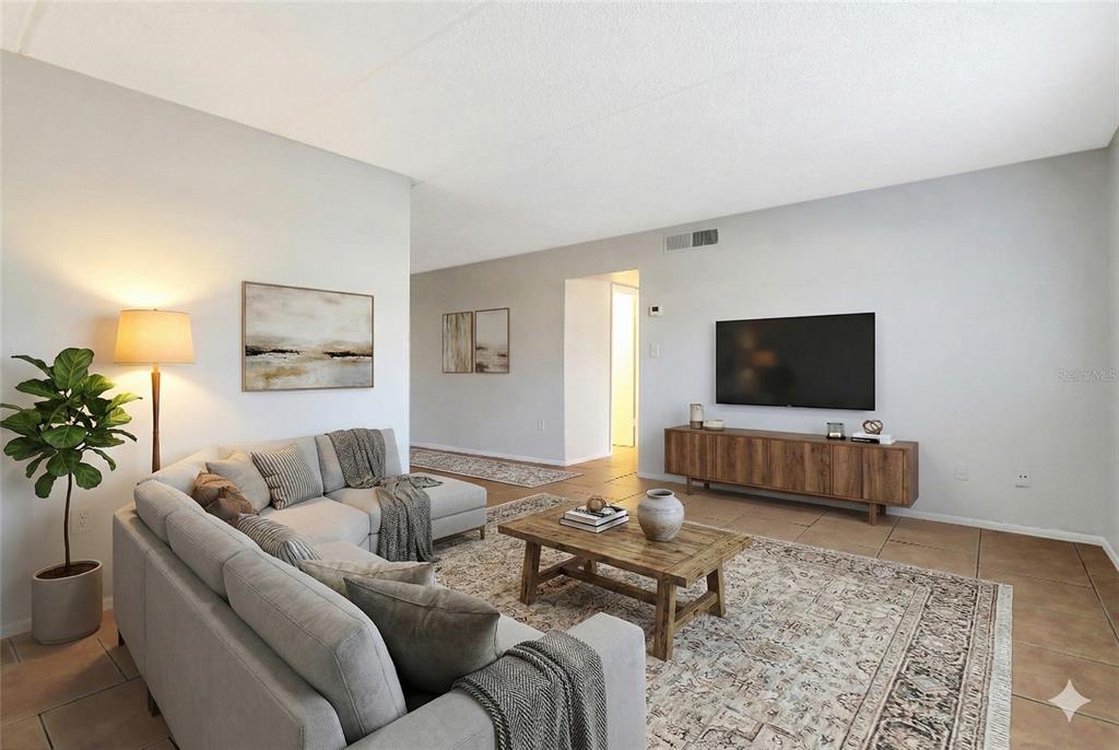 1902 Honour Road, Unit 11 Orlando, FL 32839 - Photo 11 of 18 a living room with furniture and a flat screen tv