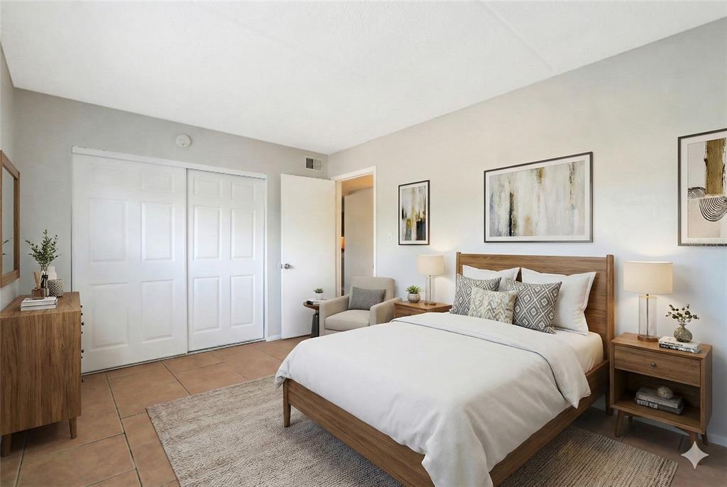 1902 Honour Road, Unit 11 Orlando, FL 32839 - Photo 13 of 18 a spacious bedroom with a bed and a couch