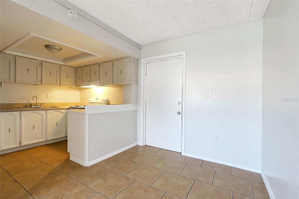 1902 Honour Road, Unit 11 Orlando, FL 32839 - Photo 4 of 18 a view of a kitchen with white cabinets and a stove top oven
