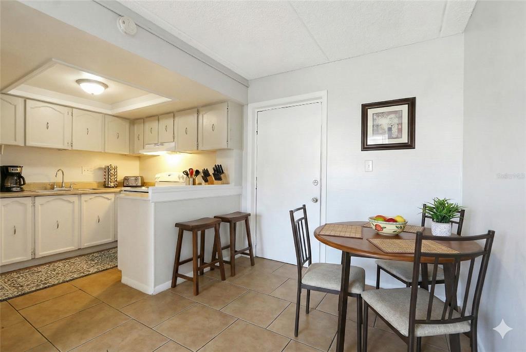 1902 Honour Road, Unit 11 Orlando, FL 32839 - Photo 5 of 18 a kitchen with a dining table and chairs