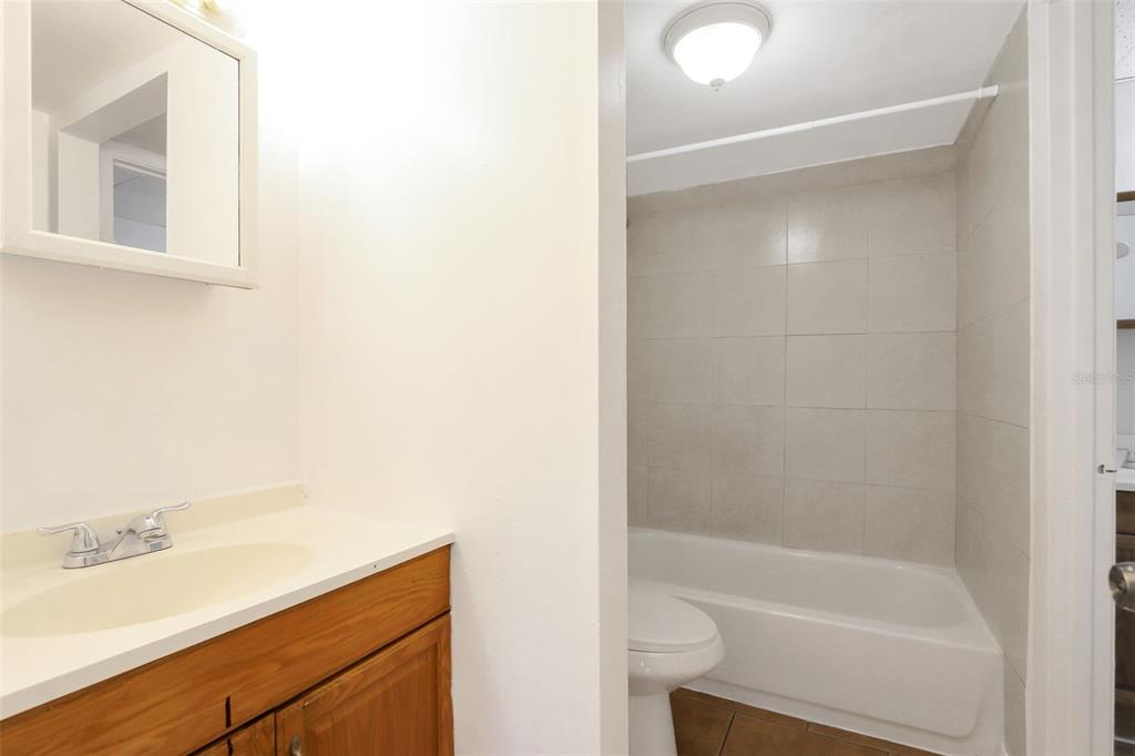 1902 Honour Road, Unit 11 Orlando, FL 32839 - Photo 9 of 18 a bathroom with a bathtub and a sink