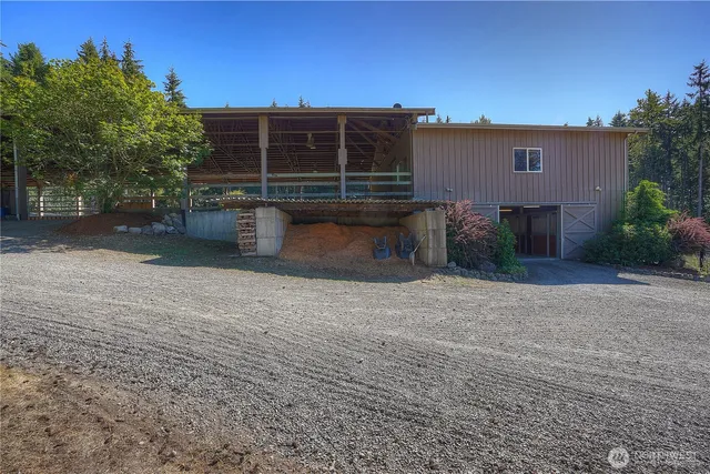 a view of a house with backyard and sitting area