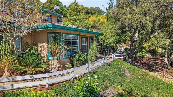 a front view of a house with garden