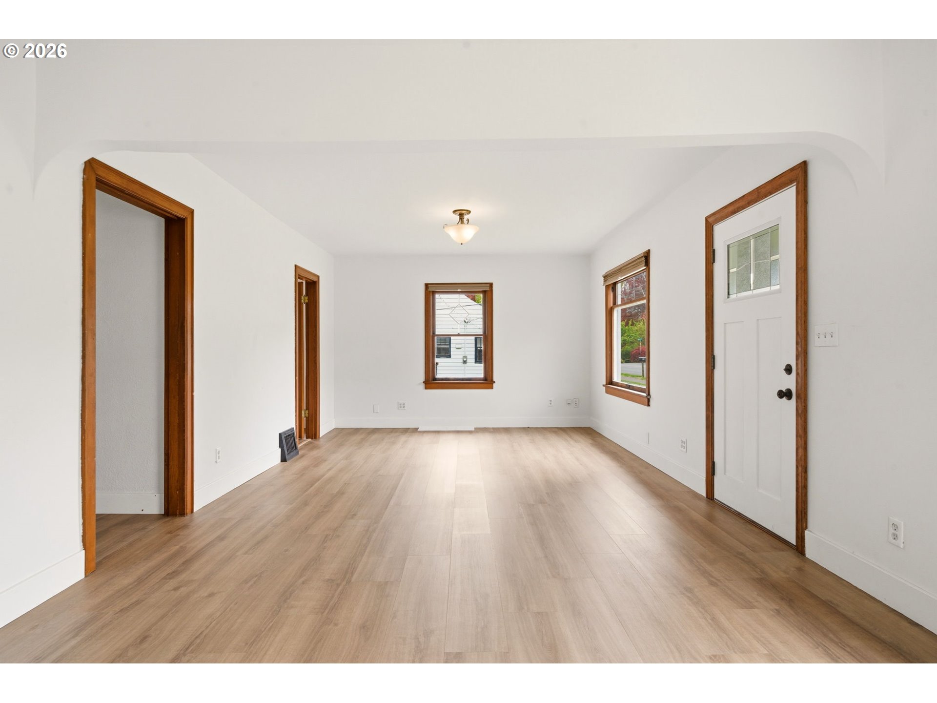 1804 Division Street Camas, WA 98607 - Photo 10 of 43 a view of an empty room with window and wooden floor