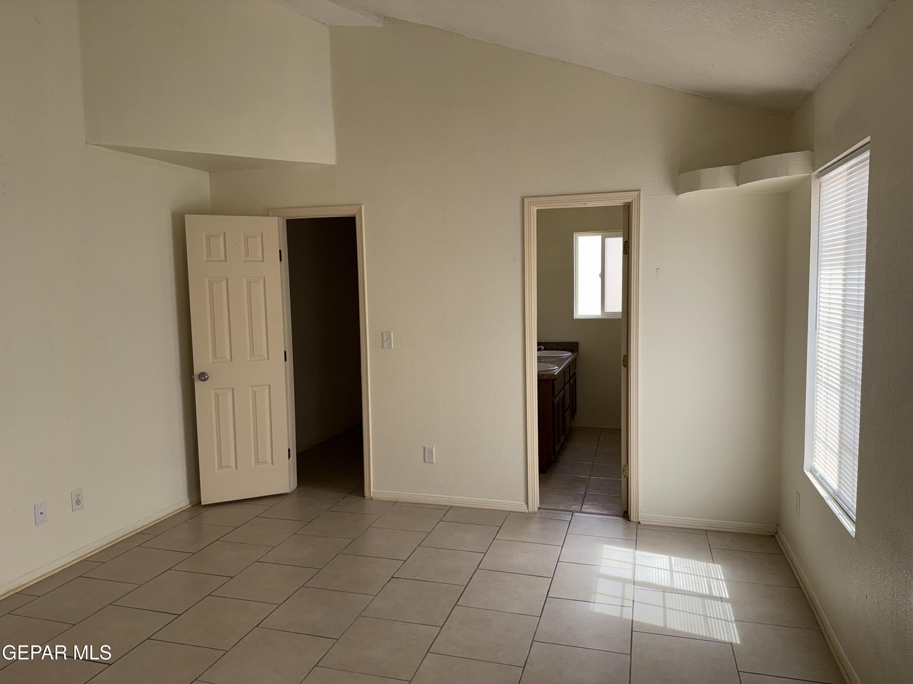 456 Passmore Road Socorro, TX 79927 - Photo 14 of 23 a view of an empty room with closet and a window