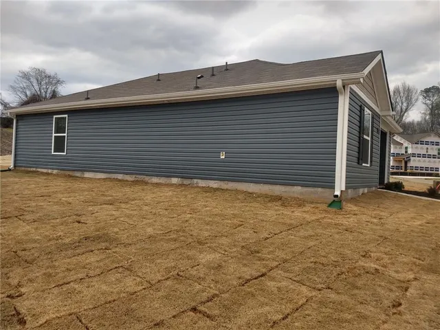 a kitchen with granite countertop a stove top oven a sink and a refrigerator