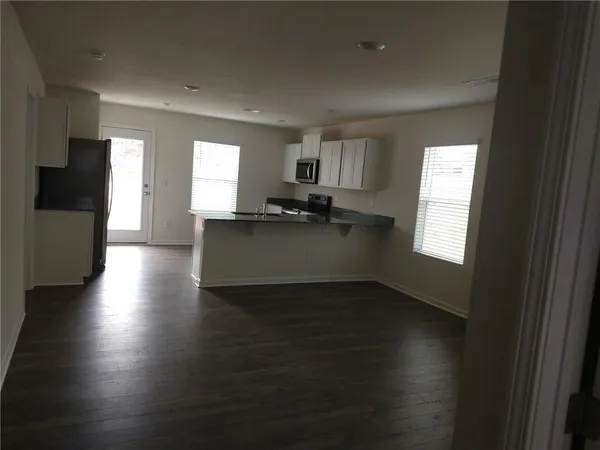 a kitchen with granite countertop a sink and a stove top oven