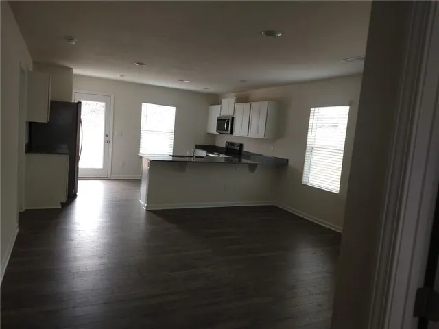 a kitchen with granite countertop a sink and a stove top oven