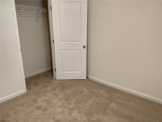 a bathroom with a granite countertop sink a toilet a mirror and shower