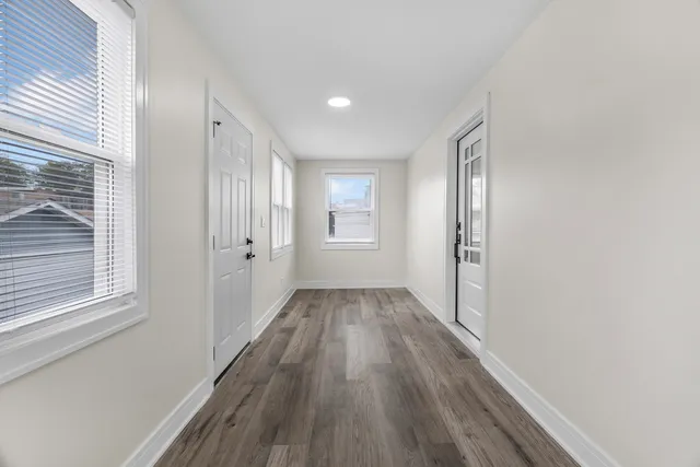 a view of a room with wooden floor and window
