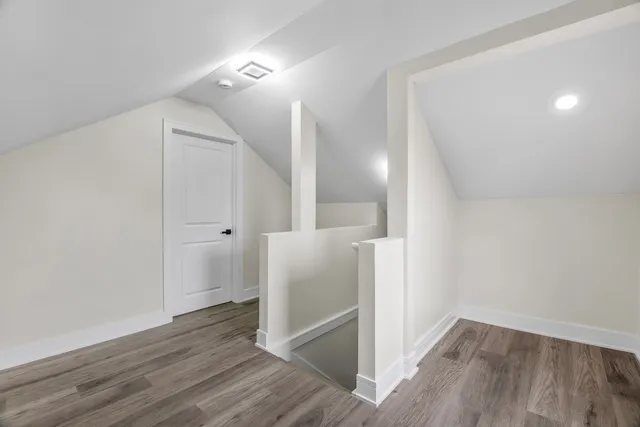 a view of a hallway with wooden floor