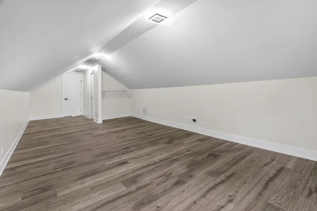 a view of a room with wooden floor
