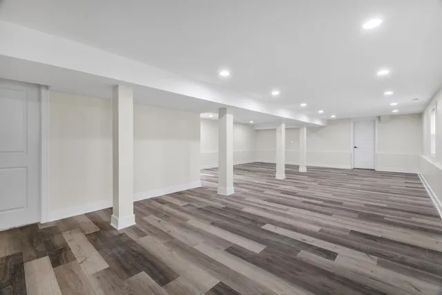a view of a room with wooden floor and window