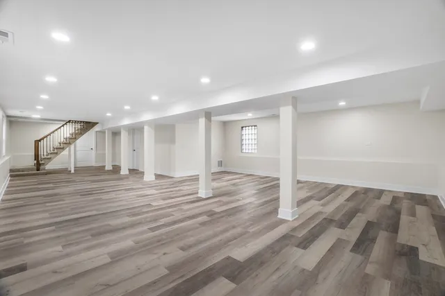 a view of empty room with wooden floor