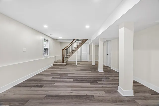 a view of a room with wooden floor and white walls