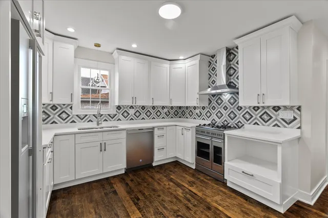 a kitchen with granite countertop white cabinets and white appliances
