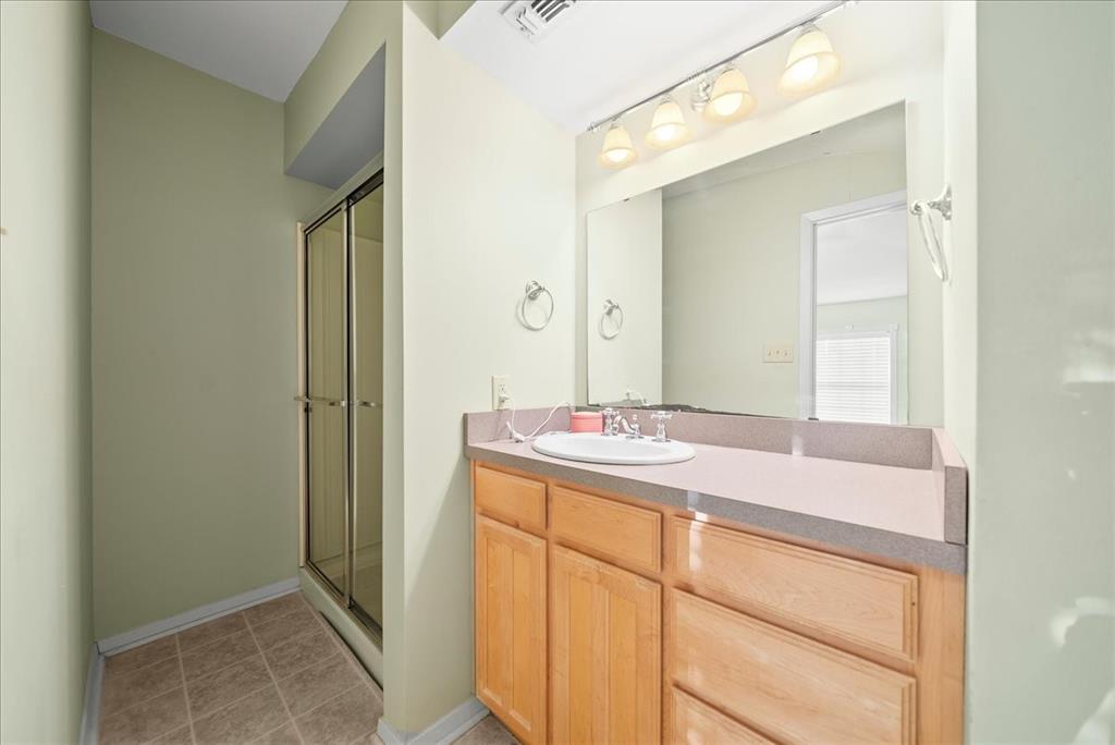 101 North 7th Street Krum, TX 76249 - Photo 15 of 26 Full bath featuring vanity, a stall shower, and light tile patterned floors