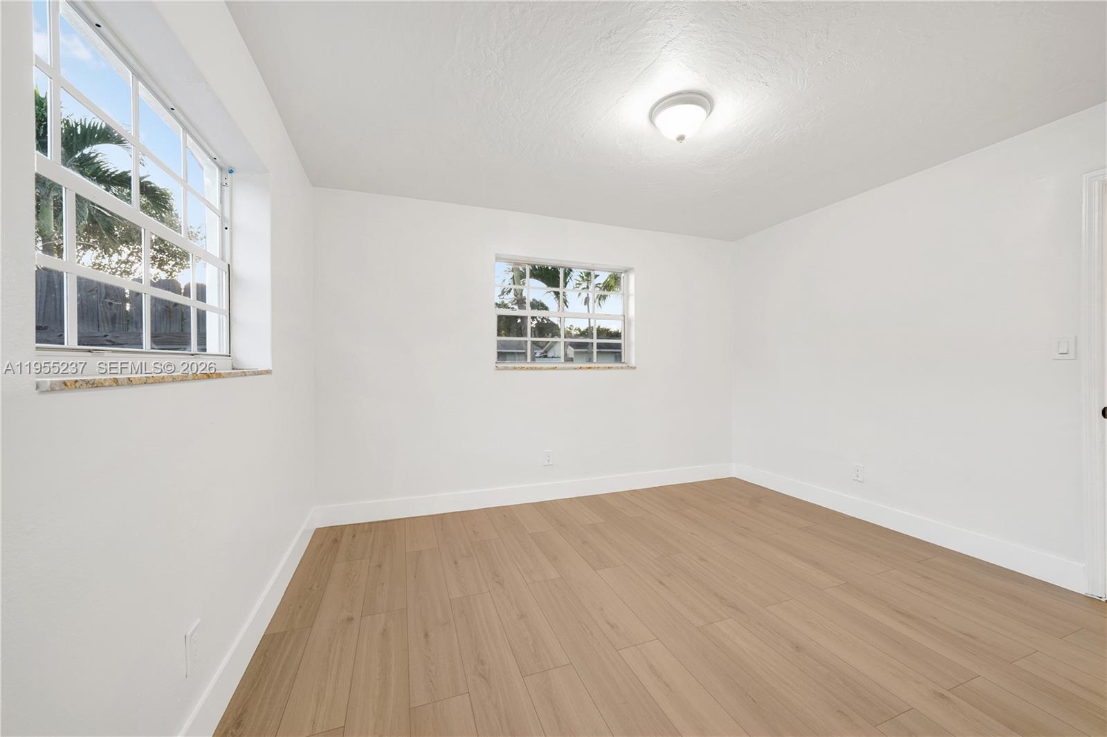 368 Southwest 64th Terrace Pompano Beach, FL 33068 - Photo 15 of 23 an empty room with a bench and a window