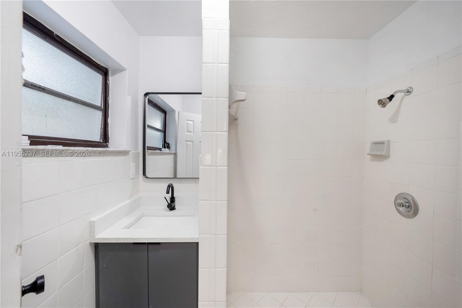 368 Southwest 64th Terrace Pompano Beach, FL 33068 - Photo 17 of 23 a bathroom with a sink a mirror and window