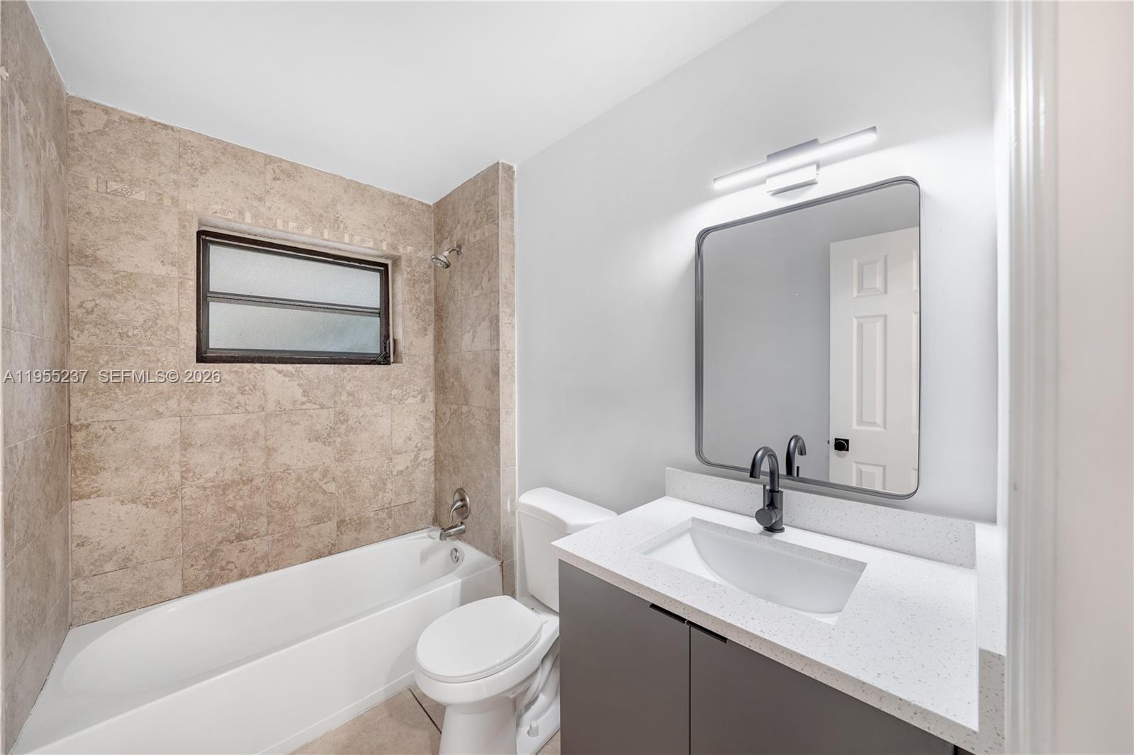 368 Southwest 64th Terrace Pompano Beach, FL 33068 - Photo 18 of 23 a bathroom with a toilet a sink a mirror and bathtub